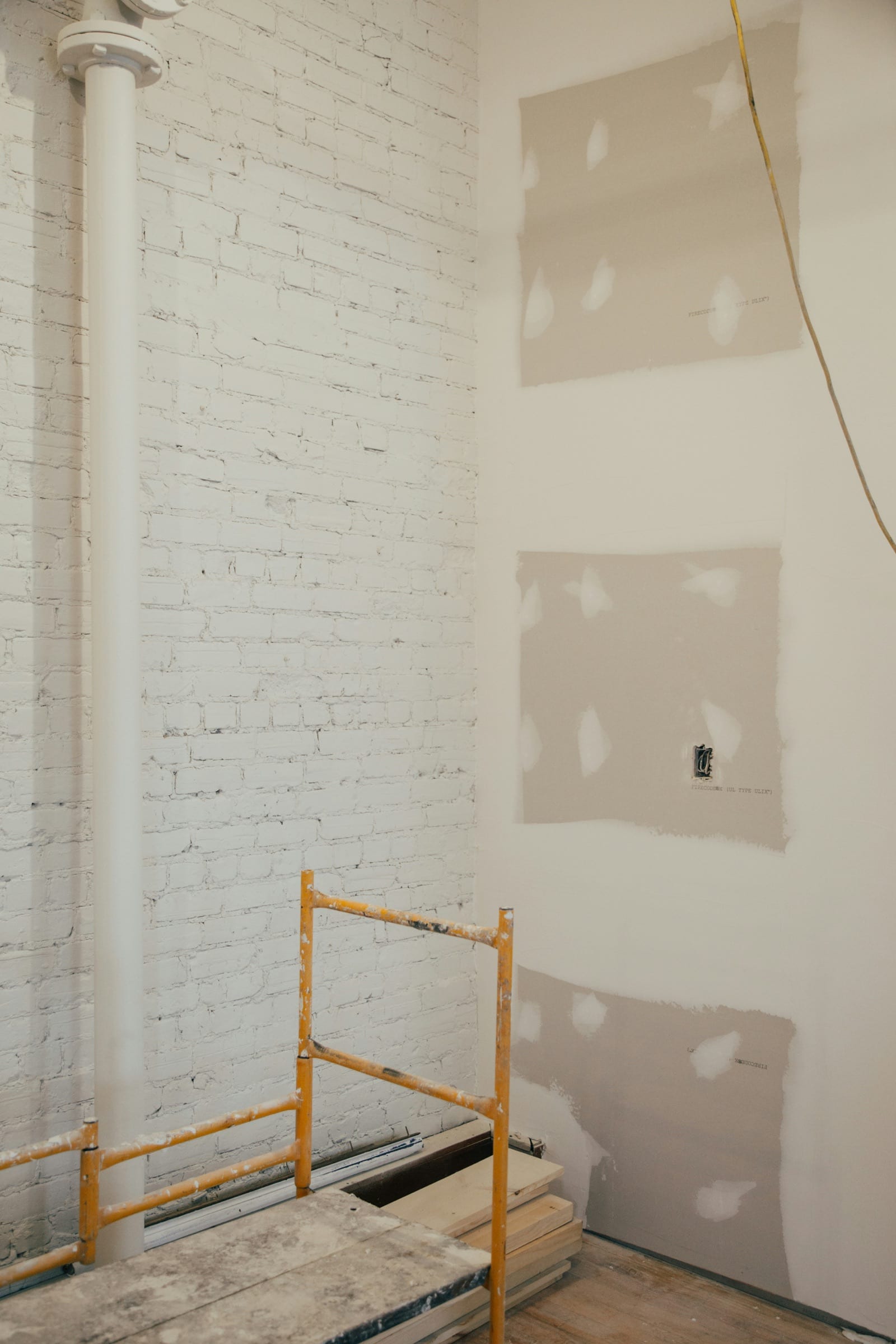 Drywall patches taped over wall damage during a small home repair visit.