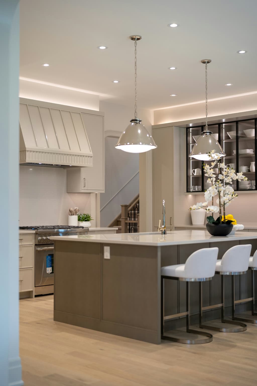 Warm wood kitchen cabinetry with marble counters and professional appliances.
