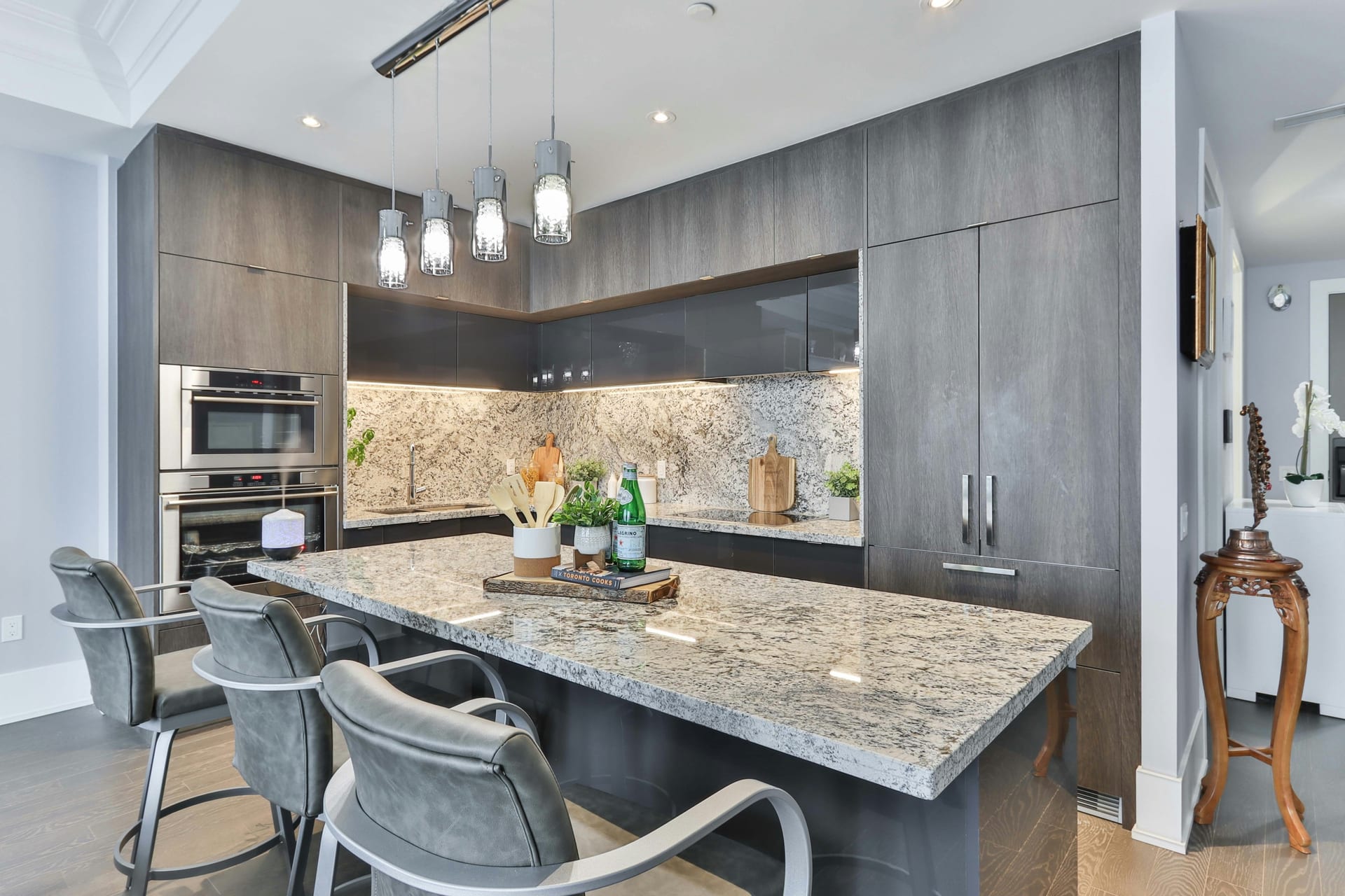 Bright white kitchen remodel with waterfall stone island and indoor-outdoor connection.